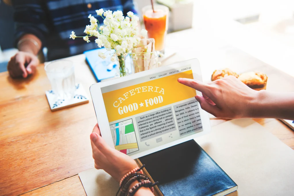 closeup-hands-holding-tablet-screen-showing-cafeteria-review